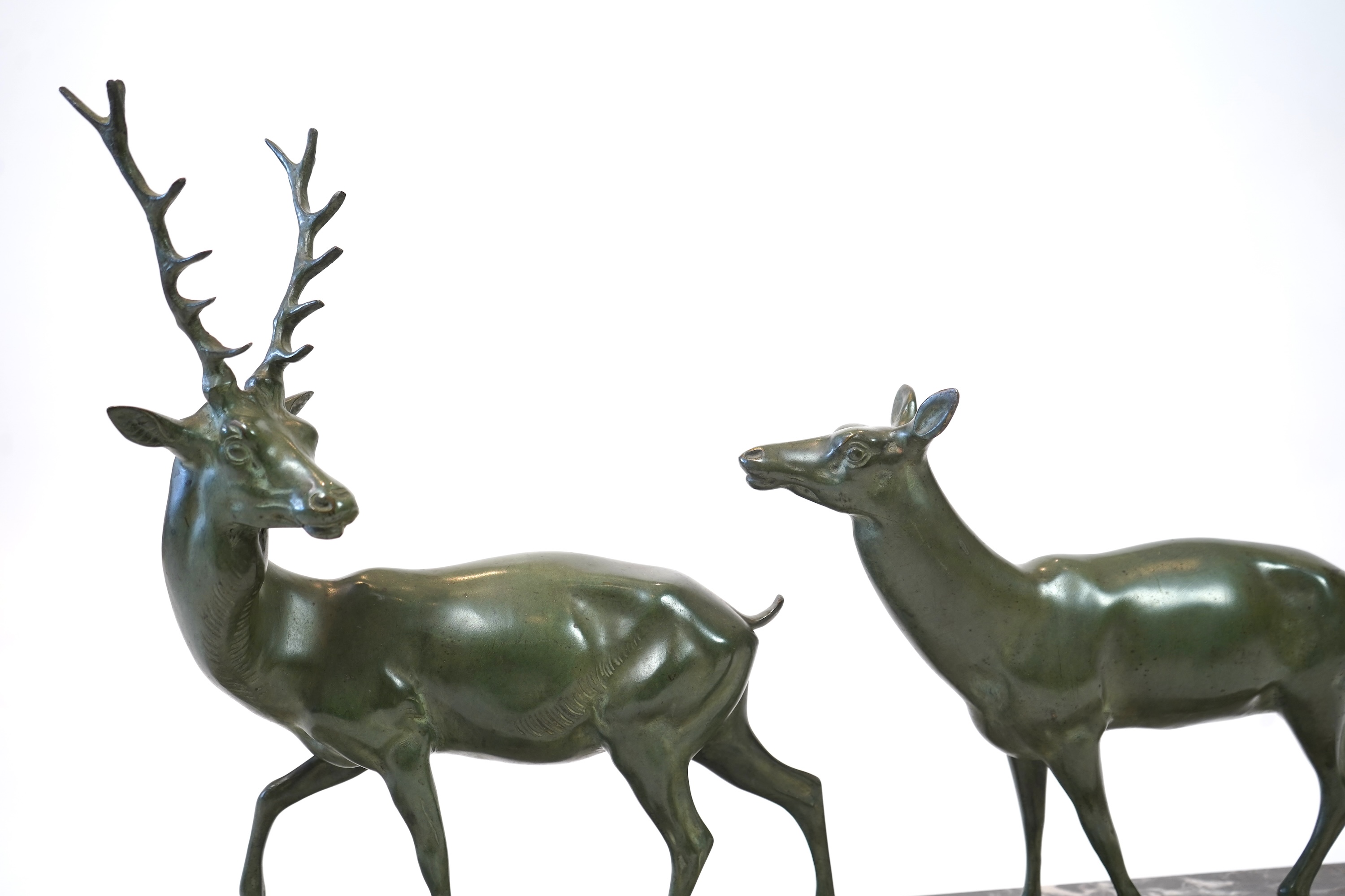 Manner of Louis-Albert Carvin, French 1875-1951, An Art Deco bronze group of a stag and doe